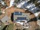 Aerial view of home showcasing roof solar panels and an inviting backyard deck and patio area at 28268 Shadow Mountain Dr, Conifer, CO 80433