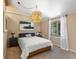 Cozy bedroom featuring a charming chandelier, neutral walls, and plush carpeting at 28268 Shadow Mountain Dr, Conifer, CO 80433