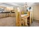 Eat-in kitchen with stainless steel appliances and granite countertops with a rustic wooden dining table and chairs at 28268 Shadow Mountain Dr, Conifer, CO 80433