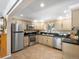 Modern kitchen featuring stainless steel appliances, tile floors, granite countertops, and ample cabinet space at 28268 Shadow Mountain Dr, Conifer, CO 80433