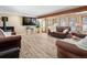 Spacious living room featuring hardwood floors, a fireplace, and large windows for ample natural light at 28268 Shadow Mountain Dr, Conifer, CO 80433