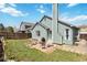 Backyard with a stone patio, outdoor seating, grill, and well-maintained green lawn at 7647 Elmwood St, Littleton, CO 80125
