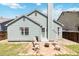 Backyard featuring a stone patio with outdoor seating, a grill, and a fire pit at 7647 Elmwood St, Littleton, CO 80125