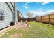 Backyard with patio area including outdoor seating, grill, and partial fence surround at 7647 Elmwood St, Littleton, CO 80125