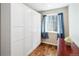 Bedroom features closet with ample storage, window with nice natural lighting, and hardwood floors at 7647 Elmwood St, Littleton, CO 80125