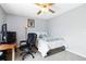 A well-lit bedroom with calming wall color and a ceiling fan providing an ideal atmosphere at 7647 Elmwood St, Littleton, CO 80125