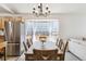 Bright dining area with large windows and a modern chandelier at 7647 Elmwood St, Littleton, CO 80125