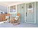 Inviting front porch with rocking chairs and charming details at 7647 Elmwood St, Littleton, CO 80125