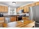 Charming kitchen with stainless steel appliances and wood cabinets at 7647 Elmwood St, Littleton, CO 80125