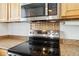 Modern kitchen stove with stainless steel appliances and decorative backsplash at 7647 Elmwood St, Littleton, CO 80125