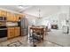 Open concept kitchen with stainless steel appliances, dining area, and living room at 7647 Elmwood St, Littleton, CO 80125