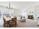 Bright living room featuring a fireplace, neutral furniture, and a dining area with a view at 7647 Elmwood St, Littleton, CO 80125
