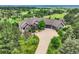 Breathtaking aerial shot showcasing lush landscaping, mature trees, and stone exterior of estate at 4725 Palmer Ridge Dr, Parker, CO 80134