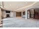 Open basement layout with a fireplace, built-in shelves, and bar area, perfect for entertaining at 4725 Palmer Ridge Dr, Parker, CO 80134