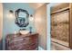 Unique bathroom with a vessel sink, wood vanity, and walk-in shower at 4725 Palmer Ridge Dr, Parker, CO 80134