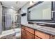 Bathroom with a glass-enclosed shower, granite countertops, and dark wood cabinets at 4725 Palmer Ridge Dr, Parker, CO 80134