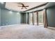 Primary bedroom with a tray ceiling, large windows, and access to the outdoors at 4725 Palmer Ridge Dr, Parker, CO 80134