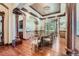 Formal dining room with elegant chandelier, detailed columns and mural walls at 4725 Palmer Ridge Dr, Parker, CO 80134