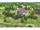 Beautiful rear exterior elevation of this home featuring an expansive lot and mature trees at 4725 Palmer Ridge Dr, Parker, CO 80134