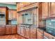 Close up of gourmet kitchen boasting professional range, custom cabinets, and tiled backsplash at 4725 Palmer Ridge Dr, Parker, CO 80134