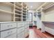 Large walk-in closet with custom shelves, drawers, and hardwood floors at 4725 Palmer Ridge Dr, Parker, CO 80134
