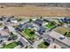 An aerial view displays a home with a large yard, barn, and garden area in a pastoral setting at 525 Remington Dr, Hudson, CO 80642