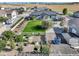 An aerial image showcases a home with a well-maintained lawn, a barn, garden area, and white fencing at 525 Remington Dr, Hudson, CO 80642