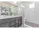 En-suite bathroom with dual sinks, granite countertops, and walk-in shower at 525 Remington Dr, Hudson, CO 80642