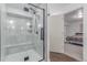 Bathroom featuring updated walk-in shower with frameless glass doors and a built in seat at 525 Remington Dr, Hudson, CO 80642