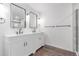 Bathroom featuring double vanities, modern fixtures, mirrors and a glass shower at 525 Remington Dr, Hudson, CO 80642