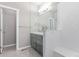 Bright bathroom with tile floors, walk-in shower, and dual sink vanity at 525 Remington Dr, Hudson, CO 80642