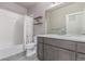 Bathroom featuring tiled bathtub, large mirror, and spacious vanity at 525 Remington Dr, Hudson, CO 80642
