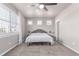Bright primary bedroom showcasing plush carpet and natural light from three windows at 525 Remington Dr, Hudson, CO 80642