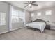 Spacious primary bedroom featuring plush carpet, abundant natural light, and ceiling fan at 525 Remington Dr, Hudson, CO 80642