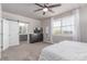 Bedroom boasts plush carpet, natural light, and en-suite bathroom with sliding barn door at 525 Remington Dr, Hudson, CO 80642