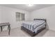 A simple bedroom with a bed, desk and window allowing for a bright, airy space at 525 Remington Dr, Hudson, CO 80642