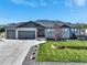 Charming single-story home featuring a well-maintained front yard and a spacious three-car garage at 525 Remington Dr, Hudson, CO 80642