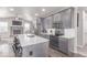 Well-appointed kitchen with stainless steel appliances, a breakfast bar, and a view into the cozy living space at 525 Remington Dr, Hudson, CO 80642