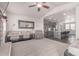 Open-concept living room flowing into the kitchen, featuring a large mirror and ample seating at 525 Remington Dr, Hudson, CO 80642