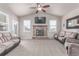 Cozy living room with a stone fireplace and large windows that bring in plenty of natural light at 525 Remington Dr, Hudson, CO 80642