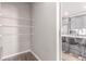 Walk-in pantry, with wire shelving, conveniently located next to the kitchen and dining area at 525 Remington Dr, Hudson, CO 80642