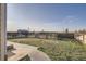Backyard features grass, a fence and a path leading to a shed in the distance at 55410 E 27Th Pl, Strasburg, CO 80136