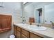 Bathroom featuring double sinks, wood cabinets, and a large mirror at 55410 E 27Th Pl, Strasburg, CO 80136