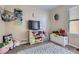 Cozy ' bedroom with carpet, storage, and a large window at 55410 E 27Th Pl, Strasburg, CO 80136