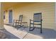 Inviting front porch featuring two rocking chairs, perfect for relaxing outdoors at 55410 E 27Th Pl, Strasburg, CO 80136