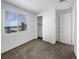 Bright bedroom featuring neutral carpet, a closet, and a large window at 12300 Hayloft Ln, Thornton, CO 80241