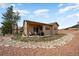 Backyard with seating and large windows overlooking a well-maintained yard at 1530 Piney Hill Pt, Monument, CO 80132