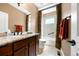 Cozy bathroom features granite countertop, vanity, framed mirror, and decorative curtain around a tub-shower at 1530 Piney Hill Pt, Monument, CO 80132