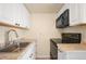 Well-lit kitchen featuring white cabinets, sleek appliances, and durable countertops at 17093 E Tennessee Dr # 211, Aurora, CO 80017