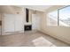 Bright open living area with a fireplace, hardwood floors, and an adjacent kitchen at 17093 E Tennessee Dr # 211, Aurora, CO 80017